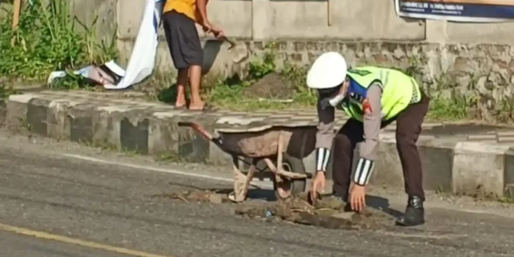 Cegah Kecelakaan, Personel Polres Parepare Aipda Herman Turun Langsung Tutup Jalan Berlubang